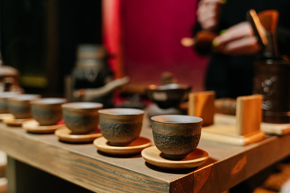 A close-up of earthenware cups arranged on a table for a traditional tea ceremony.
